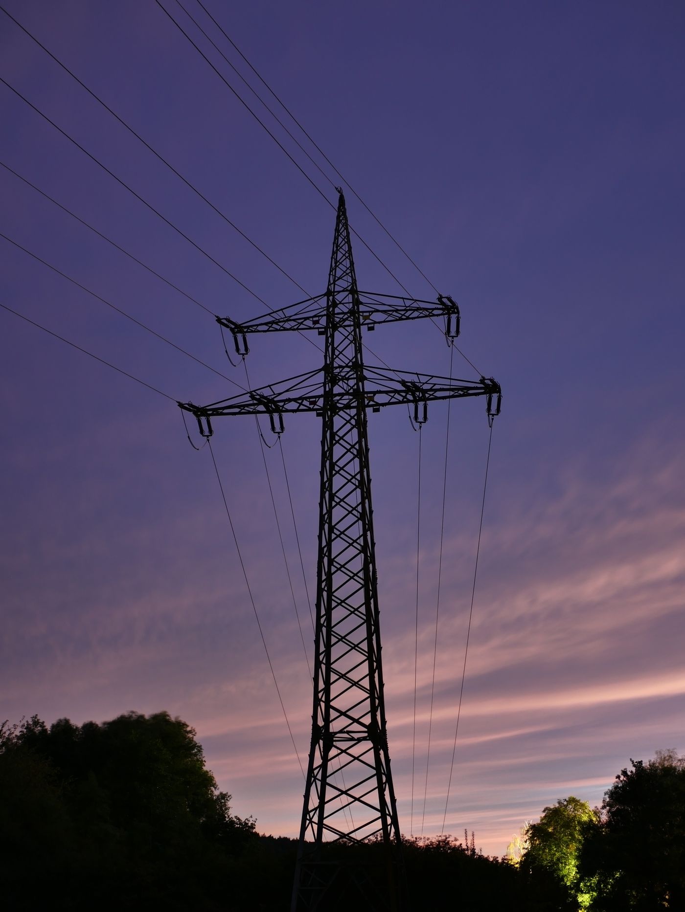 High-voltage pylon at dusk